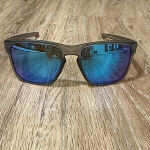 Oakley Grey Frame Sunglasses with Blue Lenses